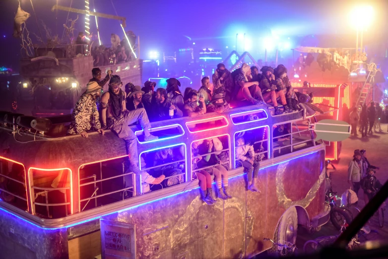 a group of people riding on top of a bus