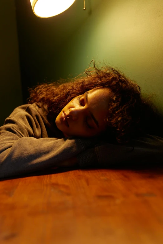 a woman is laying on the floor under the light