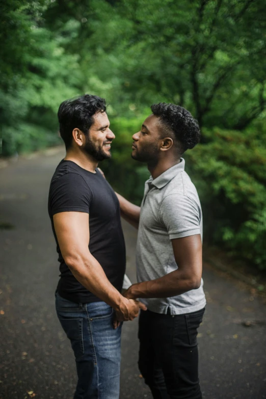 two men standing on the road by each other