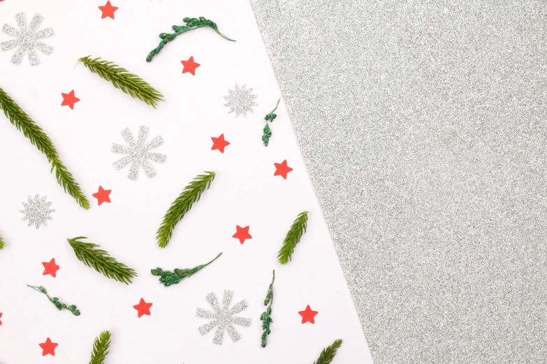 christmas decorations and snowflakes sitting on a white paper