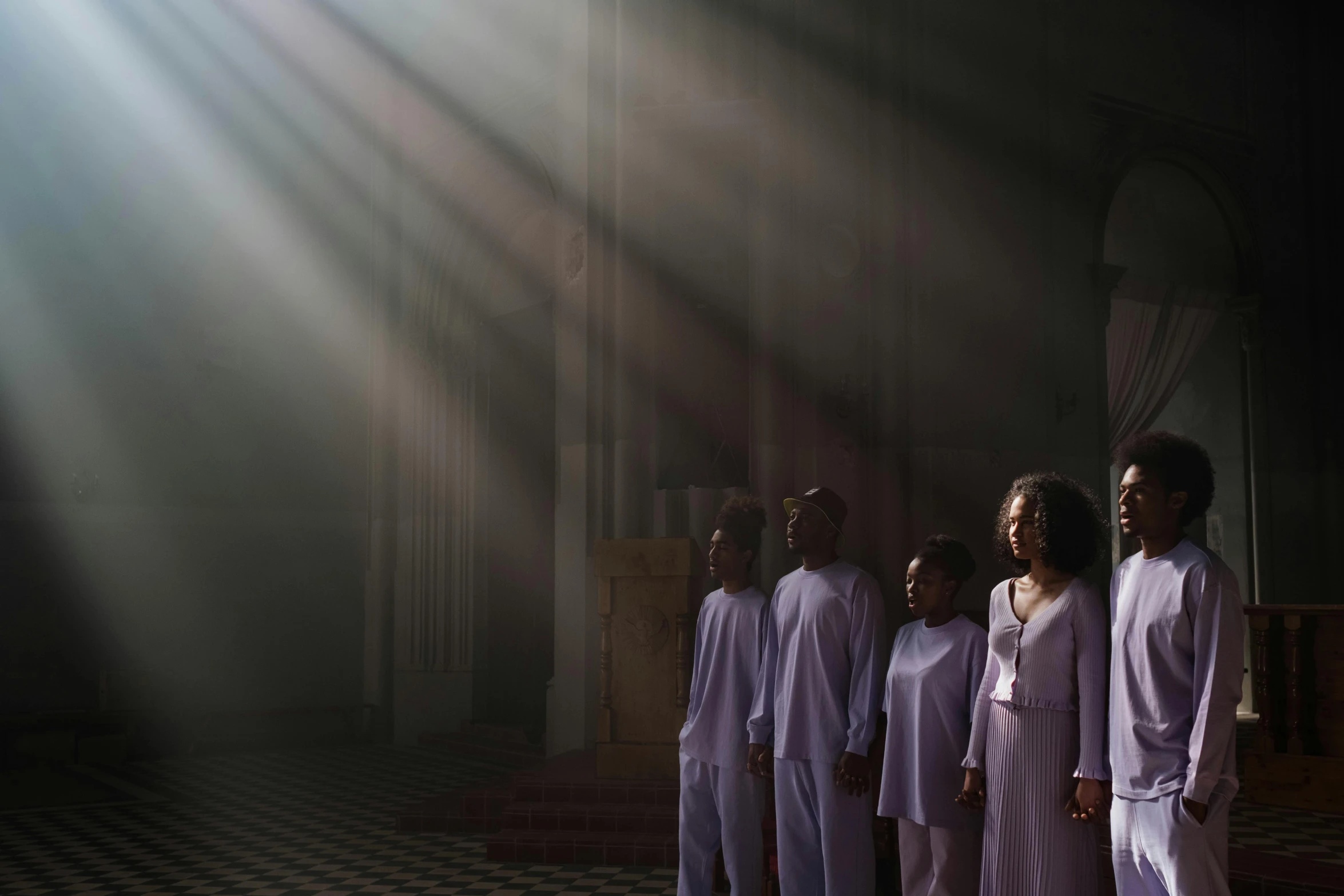 a group of people wearing white standing together