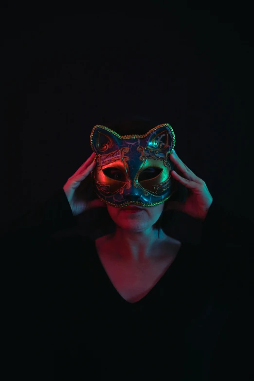 the woman is wearing a cat mask with its eyes