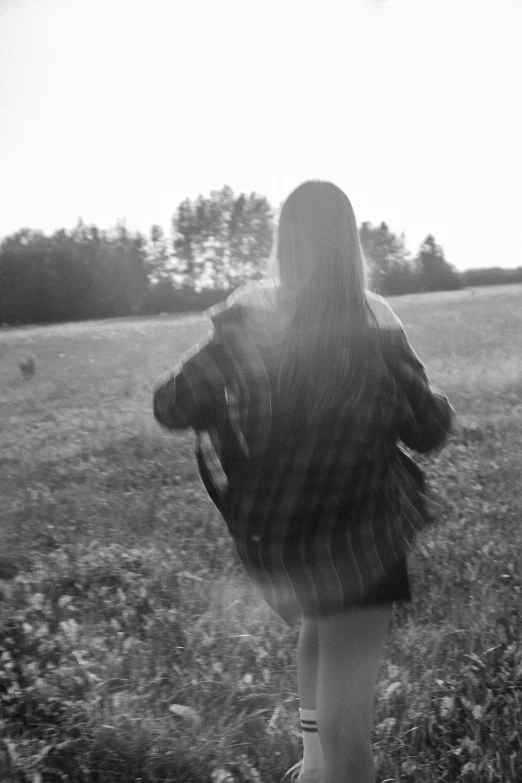 the young woman is walking her dog through the field