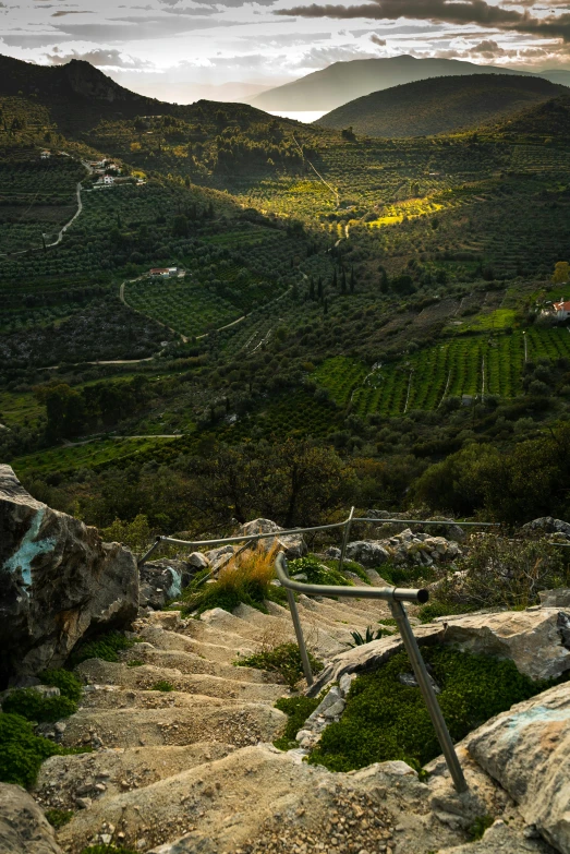 a view down a hill into a valley below