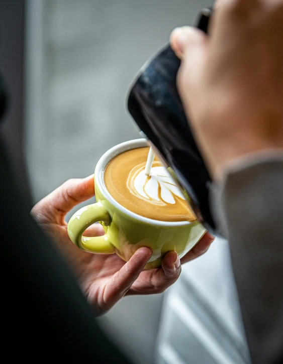 a person is holding a cup of coffee