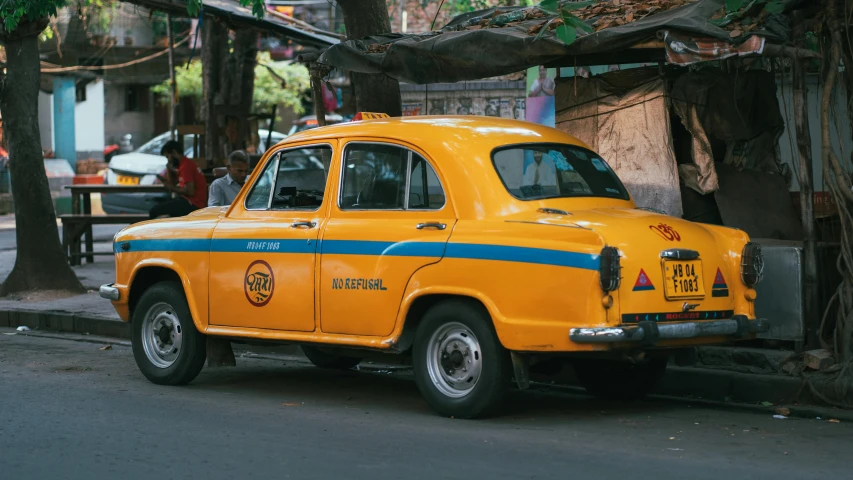 an old cab sitting in a corner on a city street