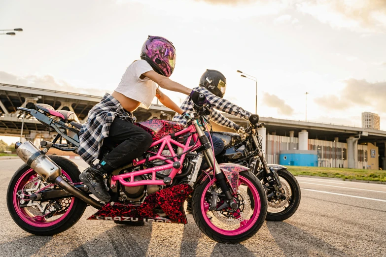 a couple of people on some pink bikes in the street