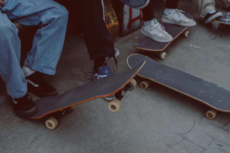 two s with skateboards in an area that looks almost empty