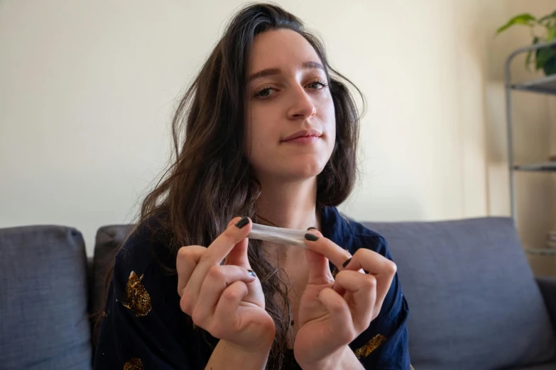 a girl with long hair brushing her teeth