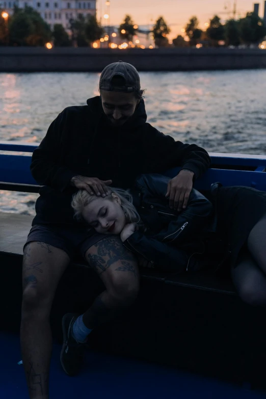 a man sitting next to a woman on a boat in the ocean