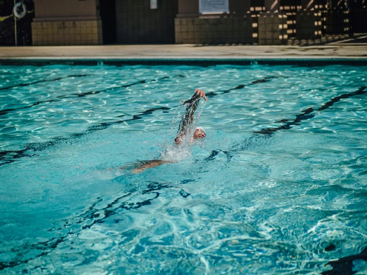 someone splashes water into a swimming pool