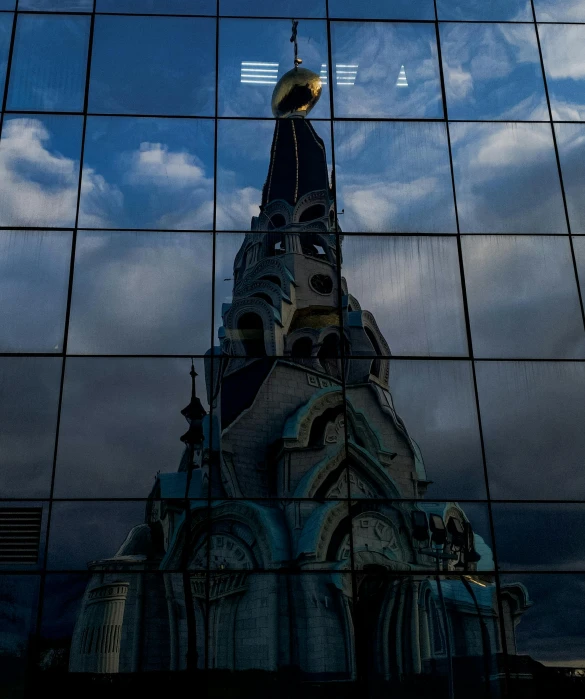 a large cathedral tower is seen behind many windows