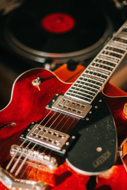 an electric guitar sits in front of the speaker