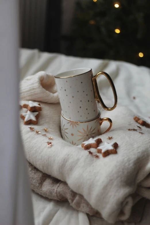 a mug on a bed with snow on the blanket