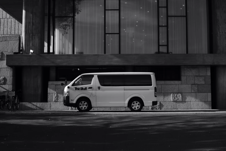 a white van parked in front of a building