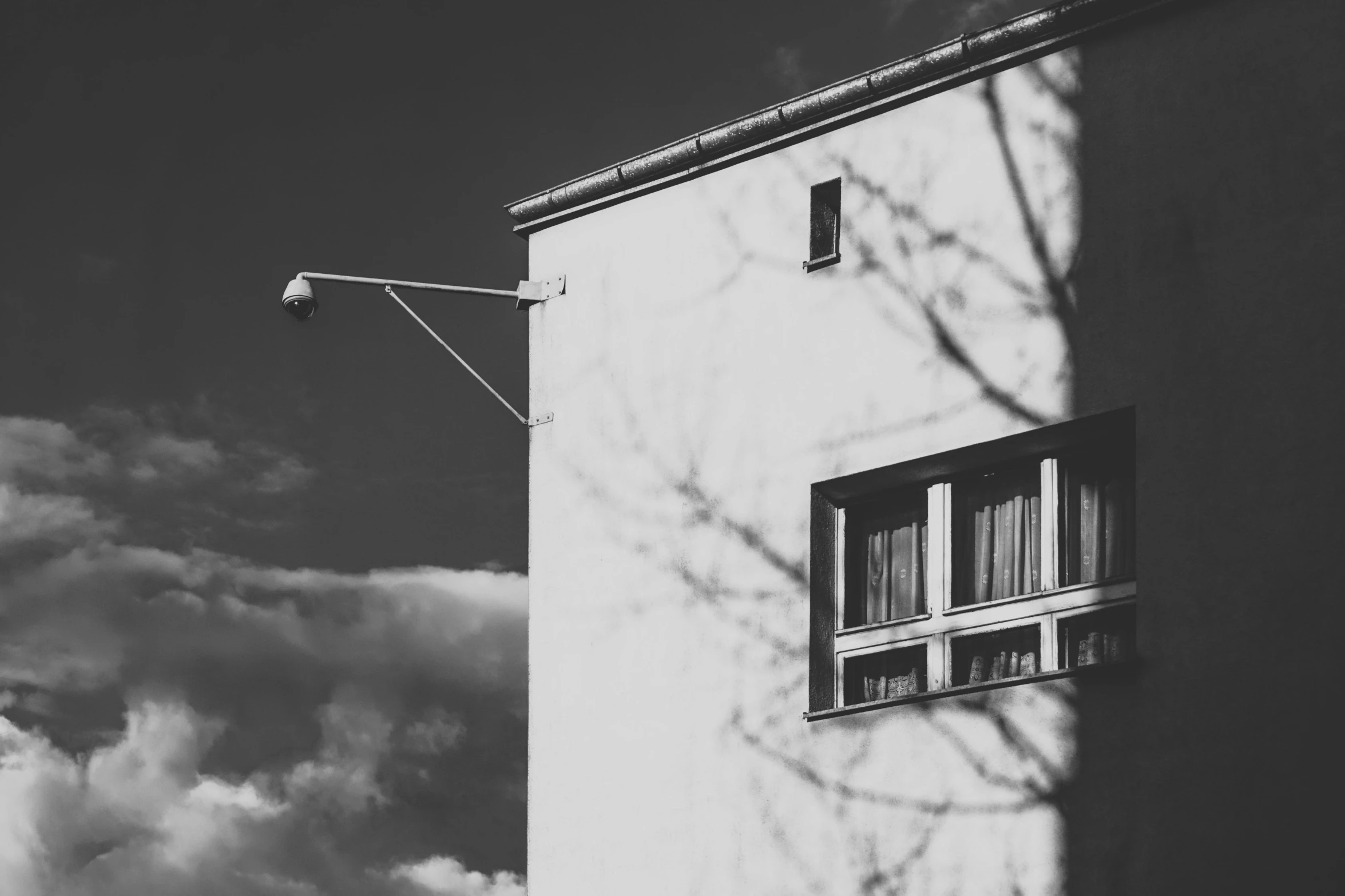 a house with two windows near a lamp post