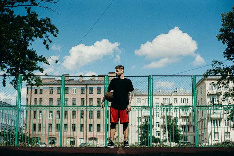 a man standing on the edge of a tennis court holding a racquet