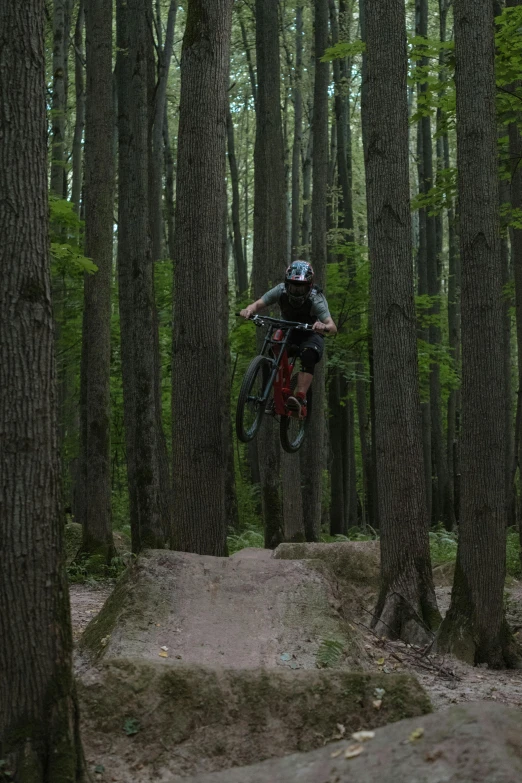 a man that is jumping in the air on a bicycle