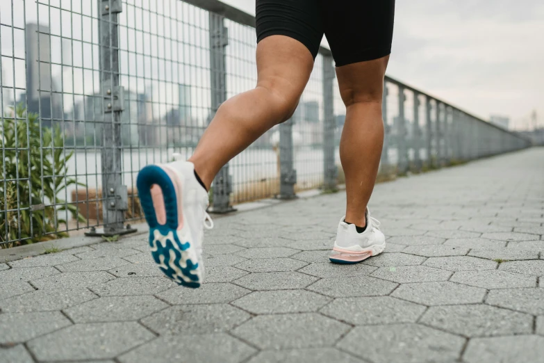 a person running down the road wearing sneakers