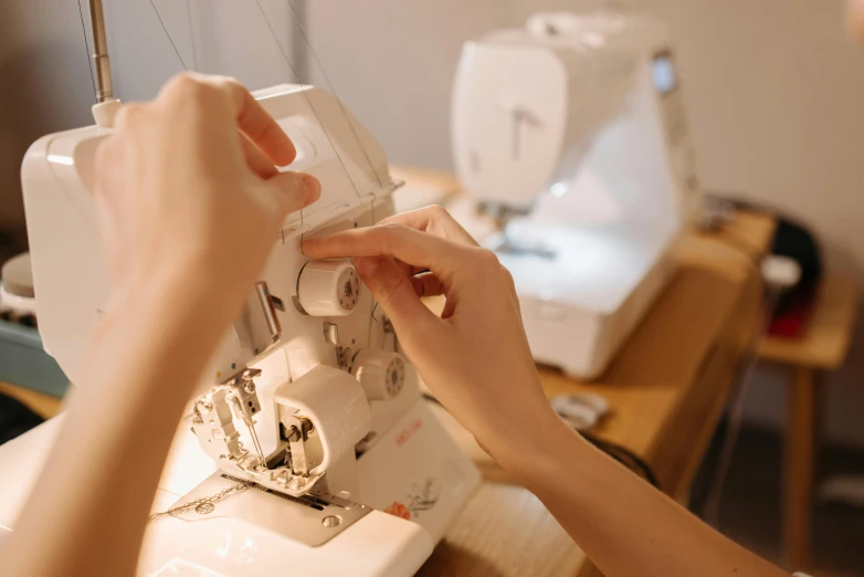 a close up of a person sewing