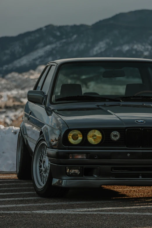 black bmw parked on top of a parking lot