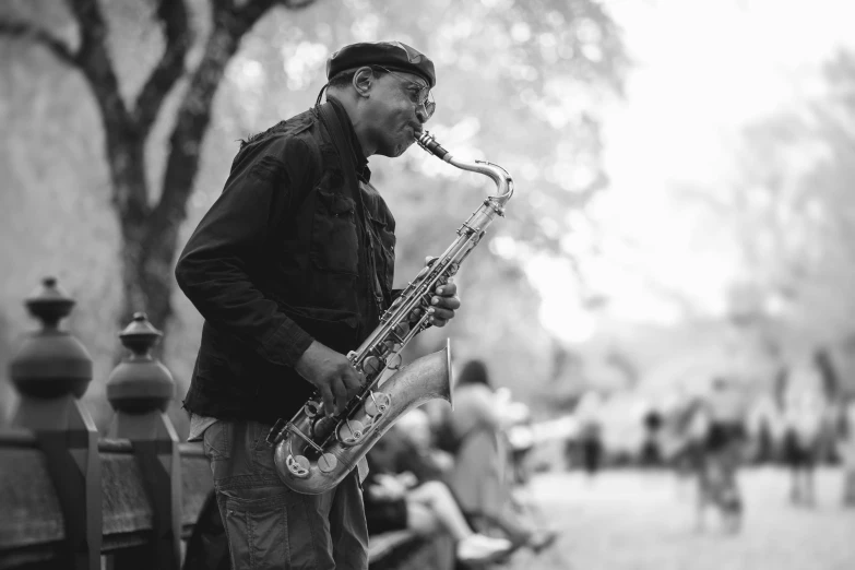 a man playing a saxophone on a city street