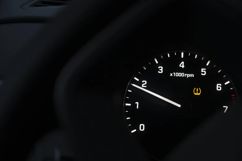 a dashboard clock of a vehicle in dark space