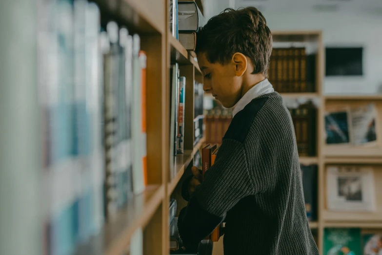 a woman checking out books on shelves in a liry