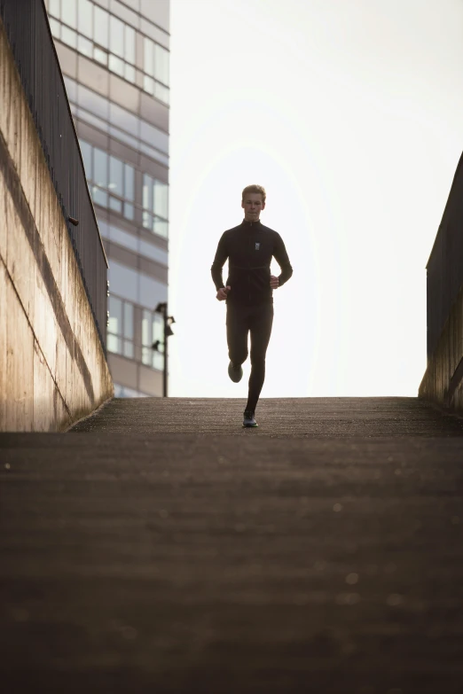 a man is running down a staircase in the city