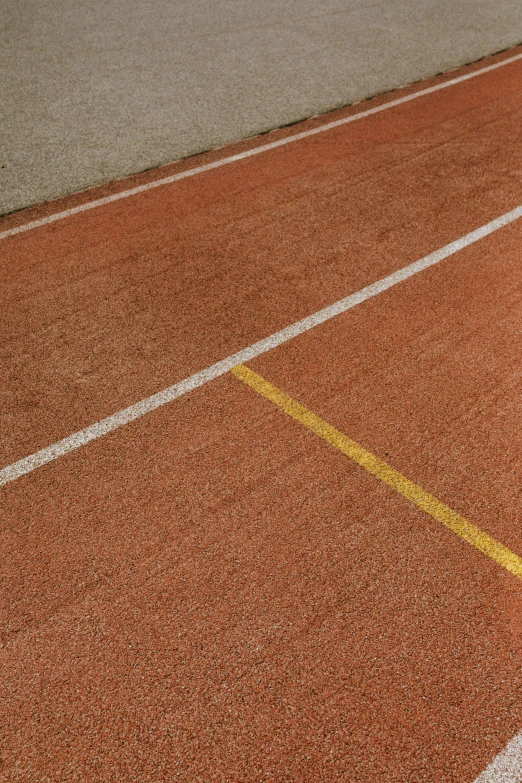 a tennis court with yellow lines painted on it