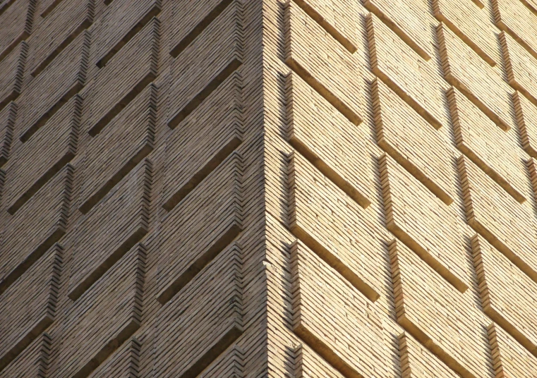the shadows of a brick building and the side of a brick wall