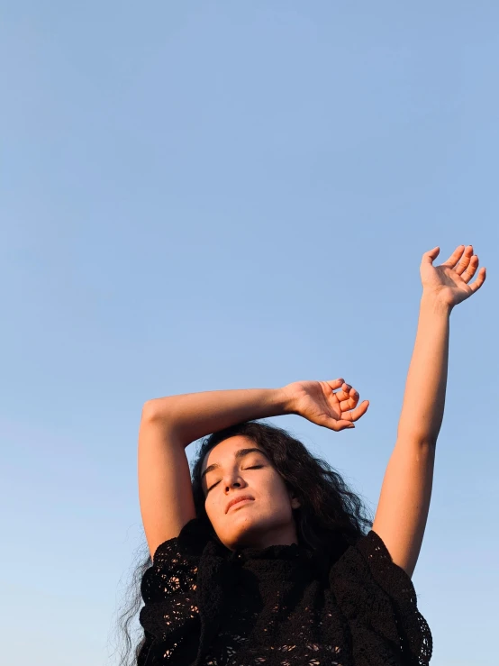 the woman in the dress is looking up at the sky