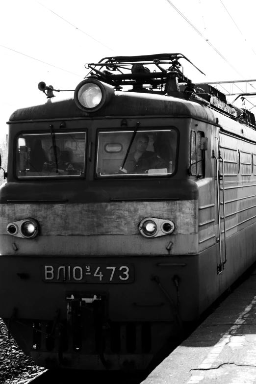 a passenger train is parked in front of a station