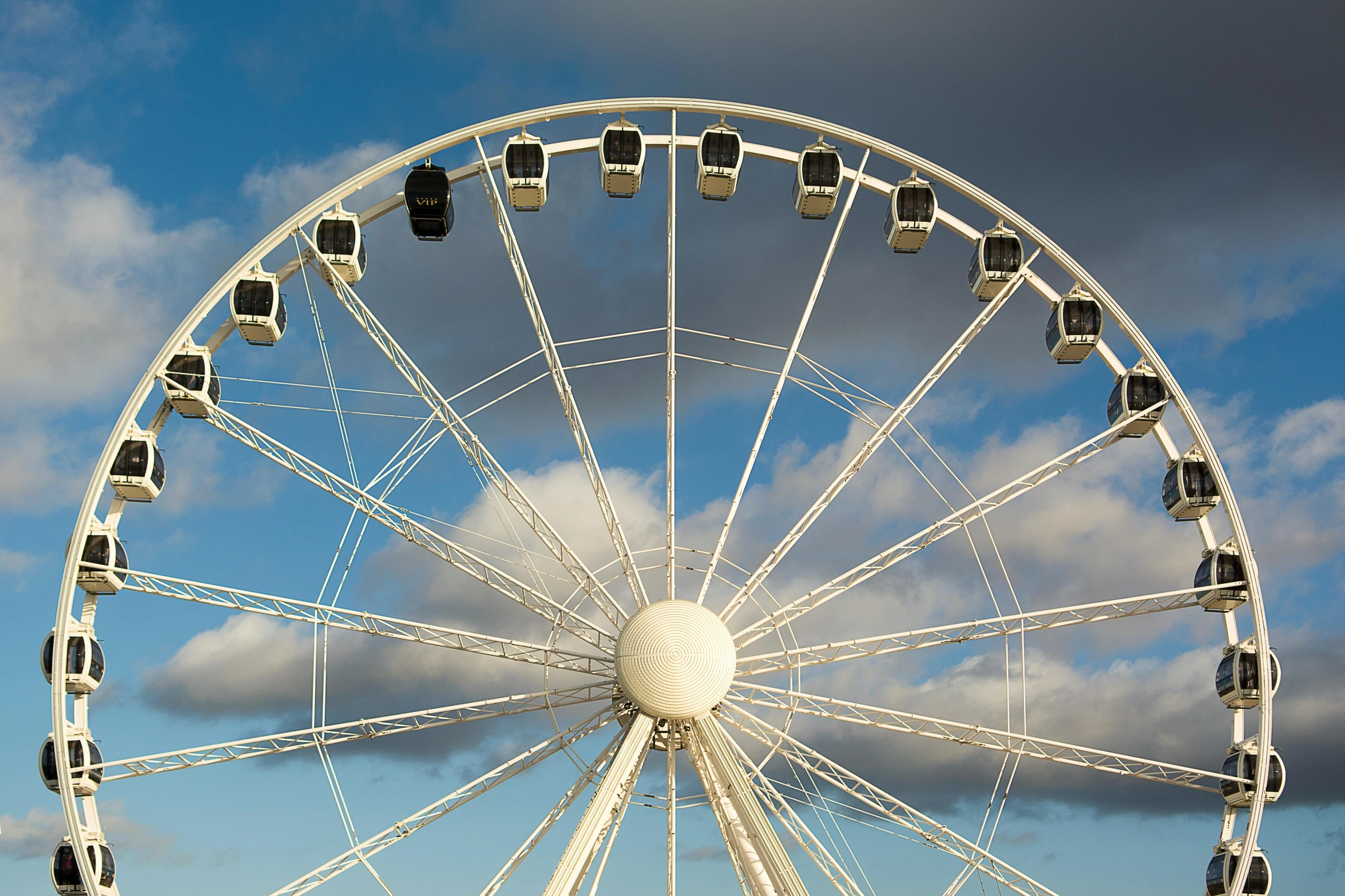 a large wheel with a sky background behind it