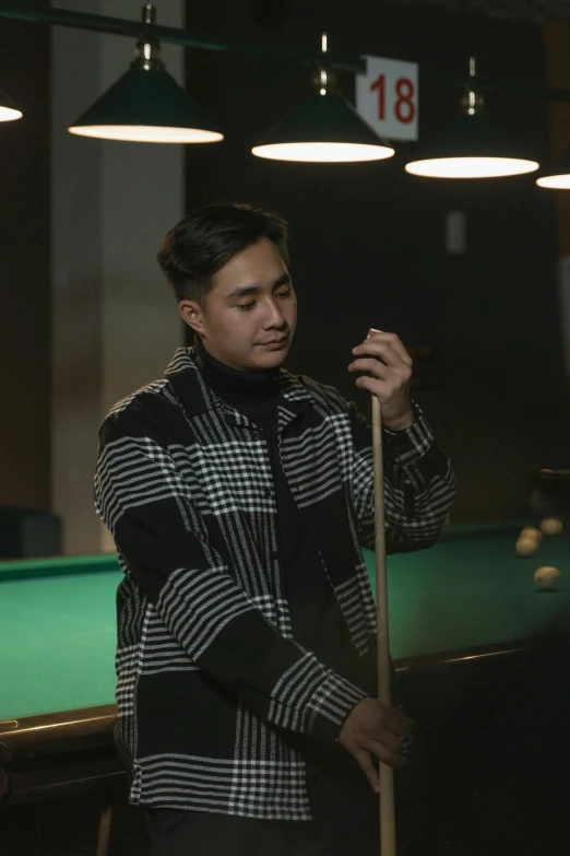 a man with a pool stick near a pool table