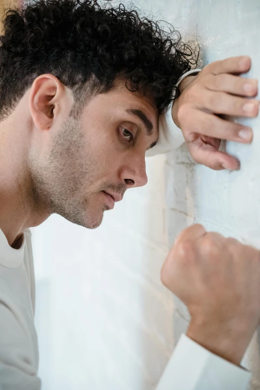 a young man looks into the mirror of his room