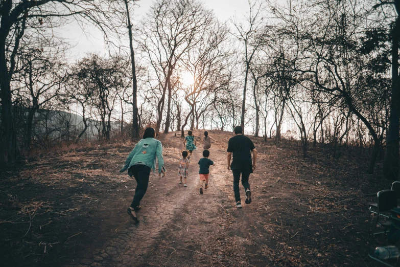 a group of people hiking up a dirt road