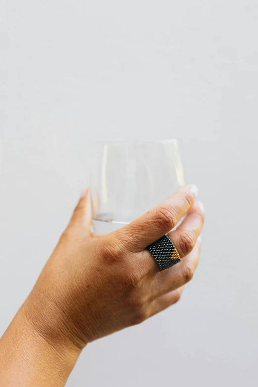 a person holding a wine glass with a napkin on the hand