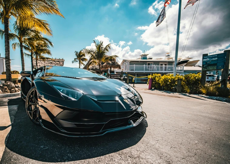 an exotic sports car parked on the side of the road