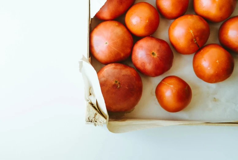 the tomatoes are in the box on the counter