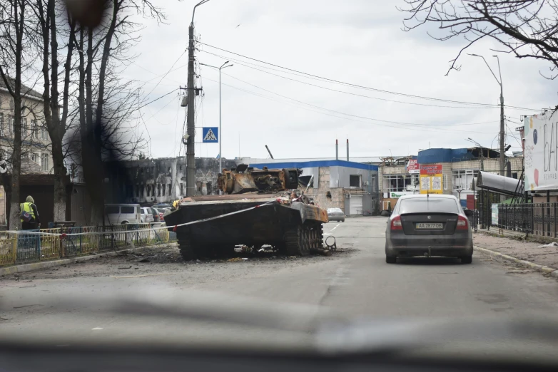 car and bulldozer on the street in a remote area