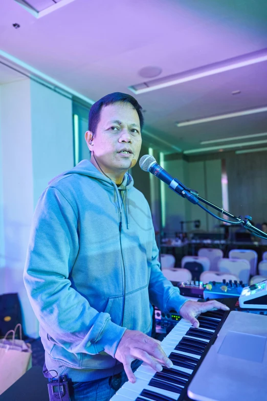 a man holding a keyboard and a microphone