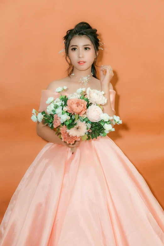 a woman in a dress holds a bouquet of flowers