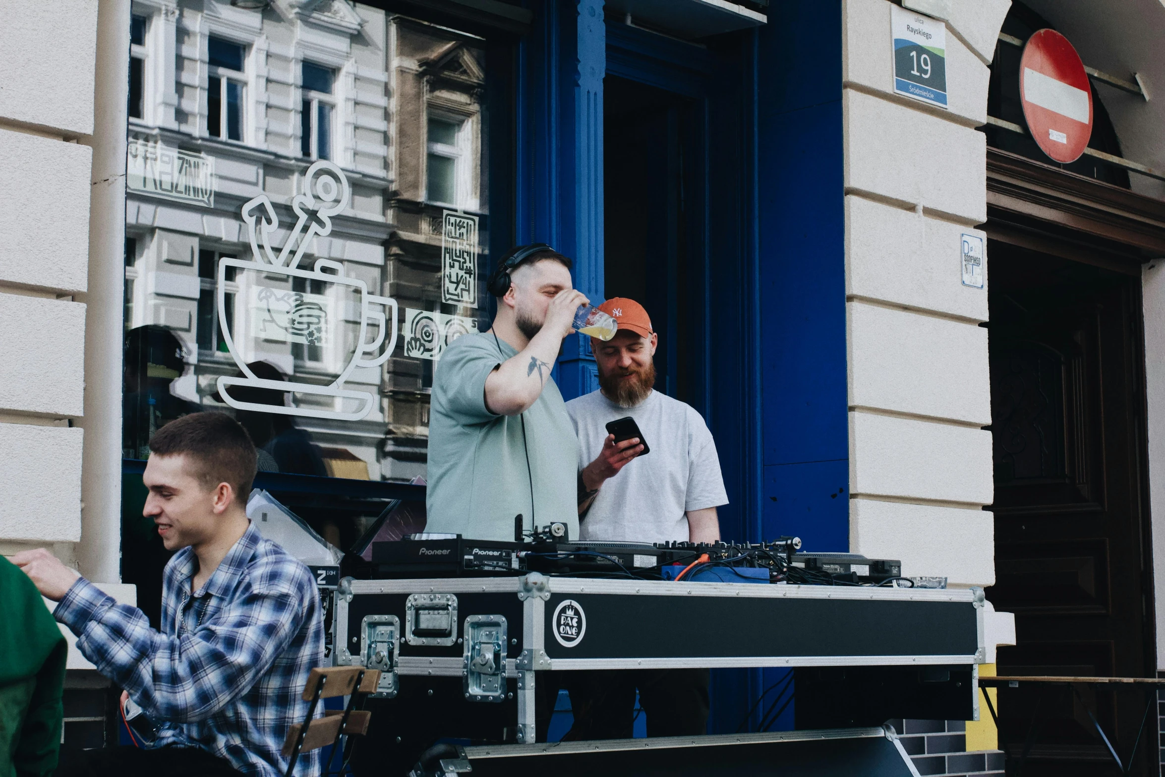 some people on a street by a dj set