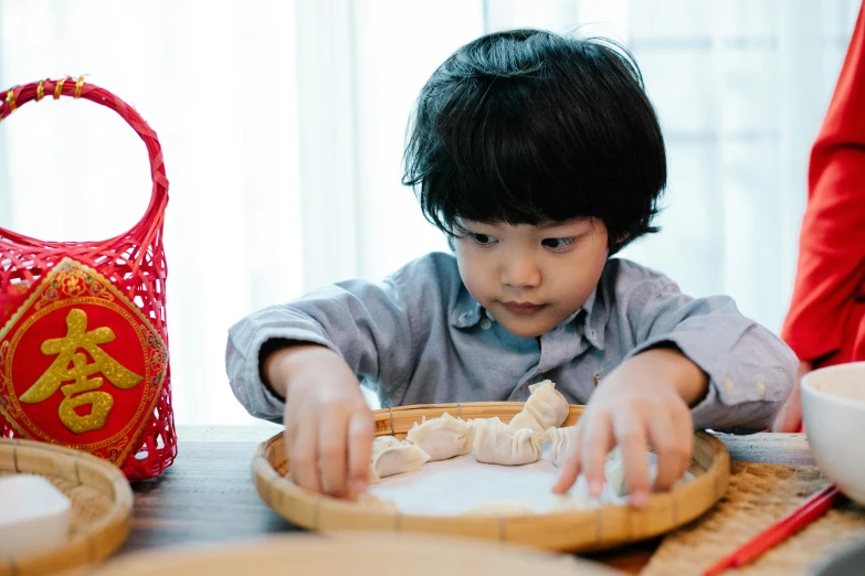 a young child is putting together food on a plate