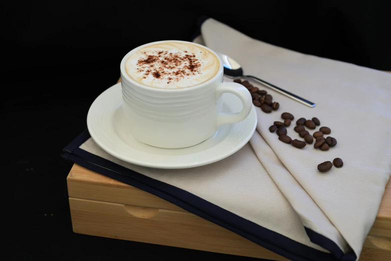 a cup of coffee on a saucer and napkin