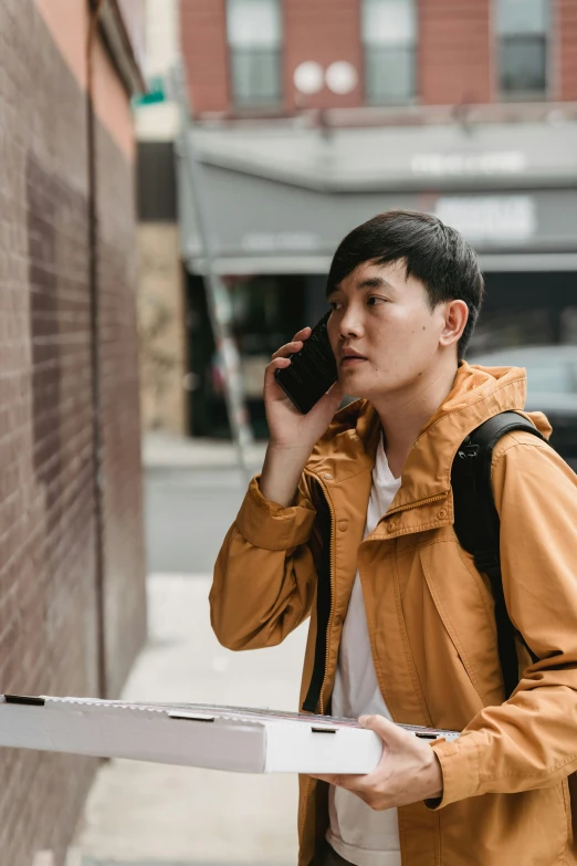 a young man on a cell phone and looking away from the camera