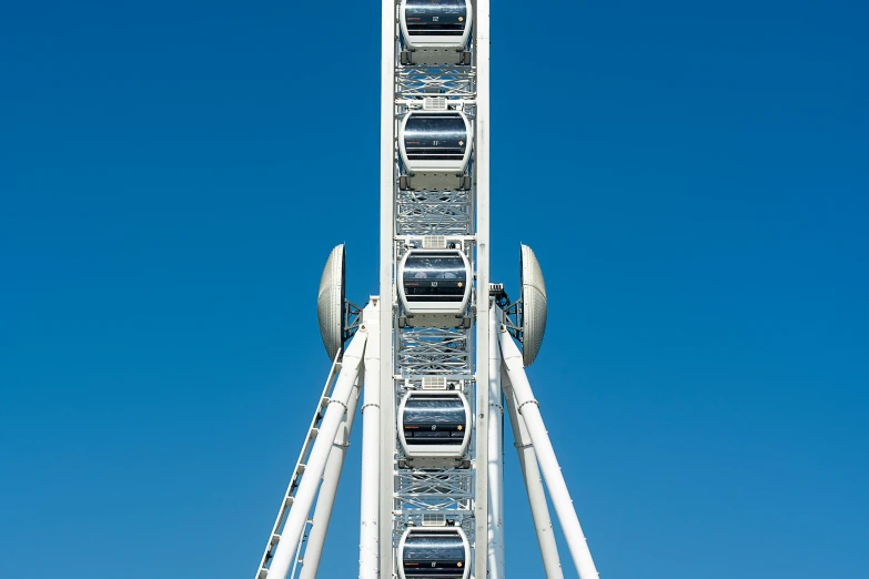 a giant blue and white roller coaster against a clear blue sky