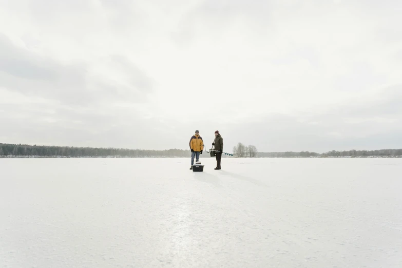 two people in their gear standing in the snow