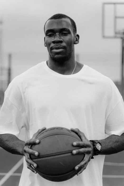 a man holding a ball in his hands with two hands